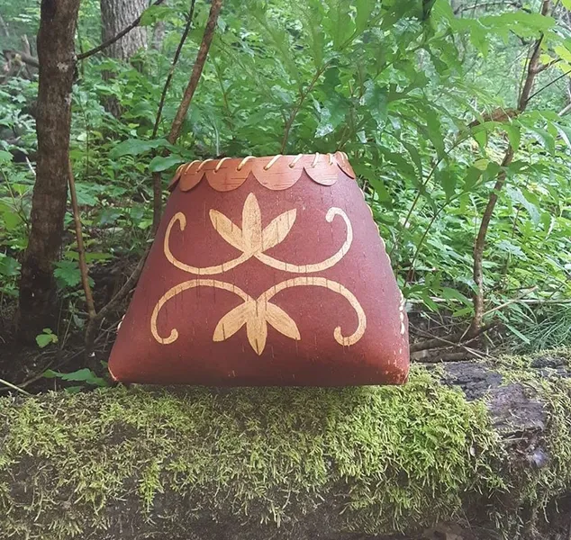 Birch bark basket with double curve designs.