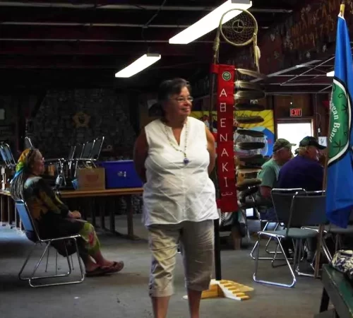 Displaying the tribal flag and the eagle staff.