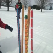 Snow snakes painted with beautiful colors and designs.