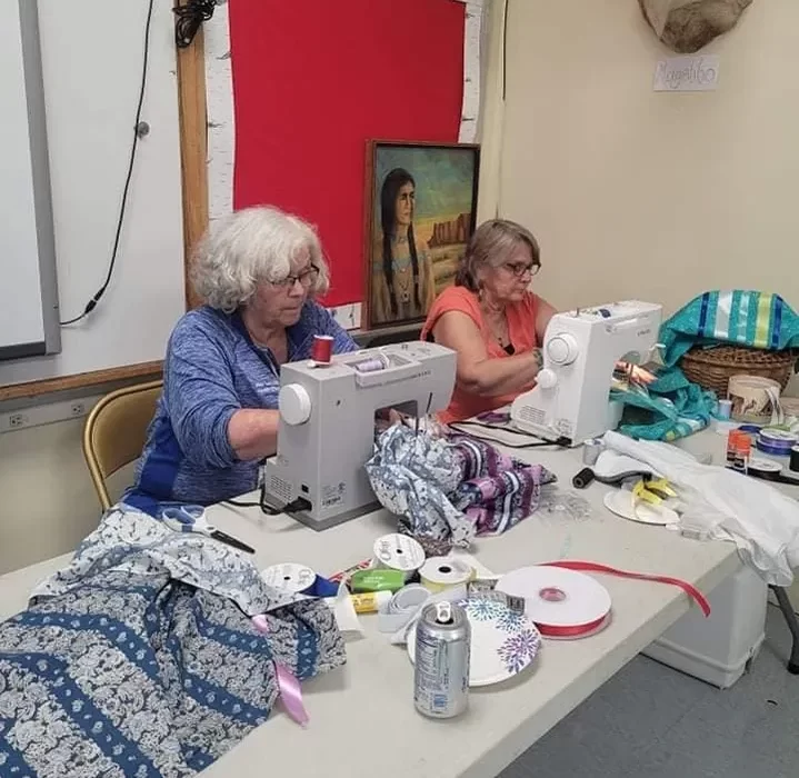 Sewing ribbon skirts.