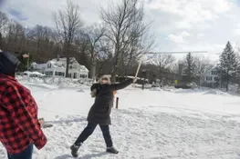 Playing snow snake games.