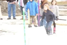 Playing snow snake games.