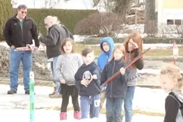 Playing snow snake games.