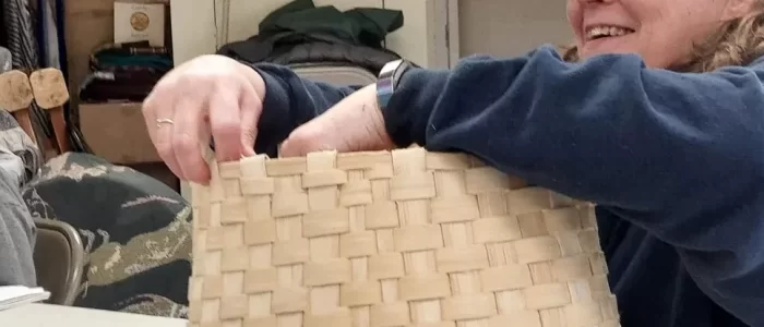 Weaving a pack basket.