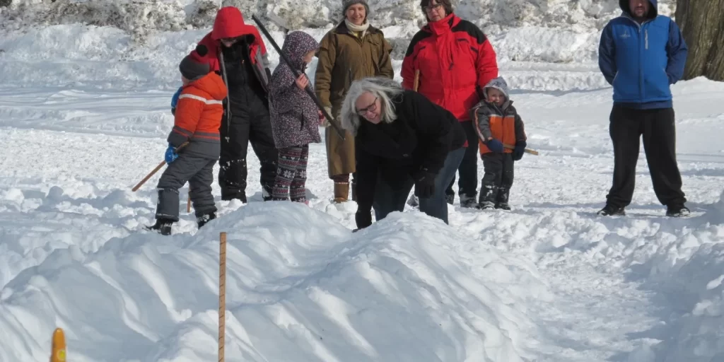 Children playing snow snake at school in the Northeast Kingdom